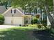 Inviting home with a well-kept lawn, stone bench, and lovely landscaping enhancing curb appeal at 10000 Barston Ct, Johns Creek, GA 30022