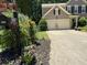 Attractive home exterior with a manicured lawn, lush landscaping, and a charming mailbox feature at 10000 Barston Ct, Johns Creek, GA 30022