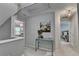 Upstairs hallway featuring painting and view into bedroom with decorative chandelier at 10000 Barston Ct, Johns Creek, GA 30022