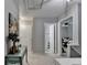 Hallway with a decorated table, painting and doorways to other rooms at 10000 Barston Ct, Johns Creek, GA 30022