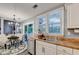 Open eat-in kitchen with wood counters and stainless steel appliances leading to backyard deck at 10000 Barston Ct, Johns Creek, GA 30022
