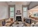 Cozy living room with fireplace, large windows, vaulted ceilings, and comfortable seating at 10000 Barston Ct, Johns Creek, GA 30022
