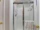 Bathroom showcasing a shower with glass door and white tile at 10000 Barston Ct, Johns Creek, GA 30022
