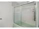 Shower-tub combination with sliding glass doors and white tile surround at 2215 Springdale Sw Rd, Atlanta, GA 30315