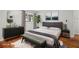 Cozy bedroom featuring a modern gray bed, dark dresser, and stylish decor at 2215 Springdale Sw Rd, Atlanta, GA 30315