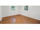 Sunlit bedroom with hardwood floors and two windows showing the neighborhood outside at 2215 Springdale Sw Rd, Atlanta, GA 30315