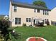 Spacious backyard with a patio dining set, green lawn, decorative landscaping, and a two-story home exterior at 3692 Ramsey Cir, Atlanta, GA 30331