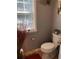 Cozy half bathroom features a toilet next to a window with blinds at 3692 Ramsey Cir, Atlanta, GA 30331