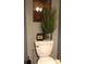 Close up of the toilet with decorative accents and plants in the powder bathroom at 3692 Ramsey Cir, Atlanta, GA 30331