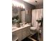 Bathroom features a double vanity with white cabinets and framed mirror at 3692 Ramsey Cir, Atlanta, GA 30331