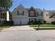 Charming two-story home with a well-manicured lawn and a two-car garage on a sunny day at 3692 Ramsey Cir, Atlanta, GA 30331