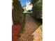 Stone pathway between homes, landscaped with mulch, rocks and greenery at 3692 Ramsey Cir, Atlanta, GA 30331