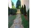 Stone pathway leads through landscaped side yard to a wooden gate at 3692 Ramsey Cir, Atlanta, GA 30331