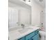 Modern bathroom with blue vanity, white countertop, and a large mirror at 420 Berckman Nw Dr, Lilburn, GA 30047