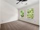 Neutral bedroom with carpet, ceiling fan, and bright natural light from two windows at 420 Berckman Nw Dr, Lilburn, GA 30047