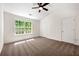 Bright bedroom with neutral carpet, ceiling fan, and ample sunlight from a large window at 420 Berckman Nw Dr, Lilburn, GA 30047
