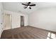 Spacious bedroom with neutral carpeting, a ceiling fan, and access to a walk-in closet at 420 Berckman Nw Dr, Lilburn, GA 30047