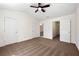 Bedroom with neutral carpet, ceiling fan, and multiple doorways, creating a flexible layout at 420 Berckman Nw Dr, Lilburn, GA 30047