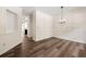 Bright dining room with modern chandelier and elegant wood floors at 420 Berckman Nw Dr, Lilburn, GA 30047
