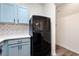 Cozy kitchen area with white countertops and a new black refrigerator at 420 Berckman Nw Dr, Lilburn, GA 30047