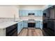 Modern kitchen with sleek appliances, countertops, and light blue cabinetry at 420 Berckman Nw Dr, Lilburn, GA 30047