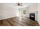 Open living room with fireplace, ceiling fan, and hardwood floors at 420 Berckman Nw Dr, Lilburn, GA 30047