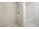 Clean, white bathroom featuring a shower, a tub and a door to a private area at 420 Berckman Nw Dr, Lilburn, GA 30047