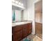 Bathroom featuring dark wood cabinets, single sink and view to the bedroom at 602 Summer Pl, Norcross, GA 30071
