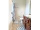 Bathroom with decorative blue floor mat, wood cabinets and single sink at 602 Summer Pl, Norcross, GA 30071