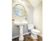 Cozy half bathroom with a pedestal sink and toilet for guests at 602 Summer Pl, Norcross, GA 30071