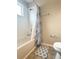 Bright bathroom features a white shower and tub combination with tiled walls at 602 Summer Pl, Norcross, GA 30071