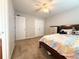 Well-lit bedroom features neutral walls, carpet, and a comfortable bed with bright comforter at 602 Summer Pl, Norcross, GA 30071