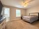 Bright bedroom with ensuite bathroom, ceiling fan, and carpet at 602 Summer Pl, Norcross, GA 30071