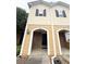 Charming townhouse with brick and siding, featuring a welcoming entrance and black shutters at 602 Summer Pl, Norcross, GA 30071
