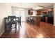 Open-concept kitchen with wood cabinetry and island, seamlessly connected to the dining area at 602 Summer Pl, Norcross, GA 30071