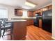 Functional kitchen with wooden cabinets, island, and black appliances, providing ample counter space at 602 Summer Pl, Norcross, GA 30071