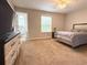 Bright main bedroom with ensuite bathroom, neutral carpet, and a ceiling fan at 602 Summer Pl, Norcross, GA 30071