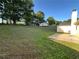 Spacious backyard with lush green grass, mature trees, and an outbuilding at 929 Wexford Way, Auburn, GA 30011