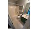 Bathroom featuring a tub, toilet, and vanity with a green cabinet at 929 Wexford Way, Auburn, GA 30011