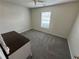 Cozy bedroom with neutral walls, carpeted floors, and a bright window at 929 Wexford Way, Auburn, GA 30011