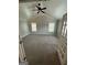 Spacious room featuring vaulted ceiling, neutral walls, plush carpet, and a ceiling fan at 929 Wexford Way, Auburn, GA 30011