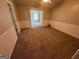 Bedroom featuring neutral walls, white trim, wainscotting, and plush carpeting at 929 Wexford Way, Auburn, GA 30011