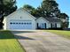 A house with an attached garage and a long driveway at 929 Wexford Way, Auburn, GA 30011