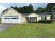 Charming single-story home with manicured lawn, attached garage, and welcoming curb appeal at 929 Wexford Way, Auburn, GA 30011
