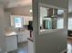 Bright kitchen featuring white cabinets, stainless steel range hood and eat-in bar at 929 Wexford Way, Auburn, GA 30011