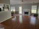Open living room with hardwood floors, fireplace and a view of the dining area at 929 Wexford Way, Auburn, GA 30011