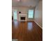 Bright living room featuring hardwood floors, a fireplace, and a glass door at 929 Wexford Way, Auburn, GA 30011