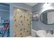 Functional bathroom featuring a shower, toilet, and sink, complemented by shelves for storage at 147 Midland Dr, Stockbridge, GA 30281