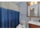 This bathroom has a blue shower curtain and a wood vanity at 147 Midland Dr, Stockbridge, GA 30281
