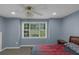 Cozy bedroom with ample natural light from the large window overlooking the front yard at 147 Midland Dr, Stockbridge, GA 30281